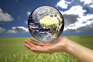 person holding planet Earth illustration